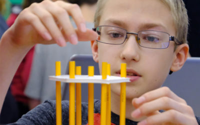 Boy building with pencils